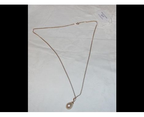 A lady's pearl pendant on 750 gold mount and chain 