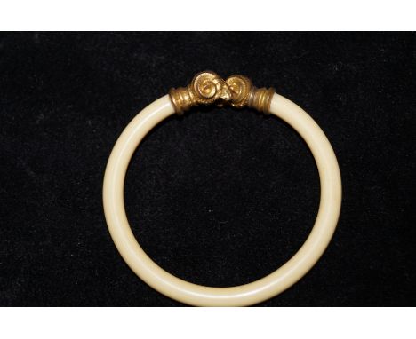 Ivory bangle with rams head terminals 