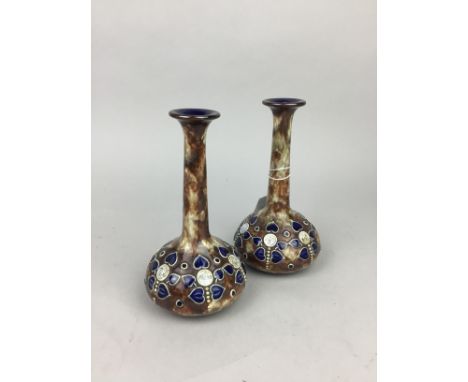 PAIR OF ART NOUVEAU ROYAL DOULTON VASES, decorated with tube lined stylised floral designs, 17.5cm high, along with a Doulton