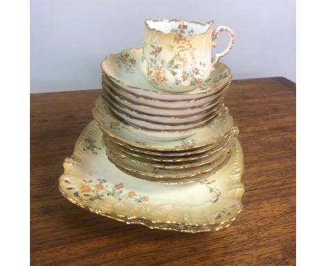 VICTORIAN LIMOGES TEA SERVICE, painted with flowers and colours in gilt, comprising 6 trios, 2 biscuit plates and a sugar bow