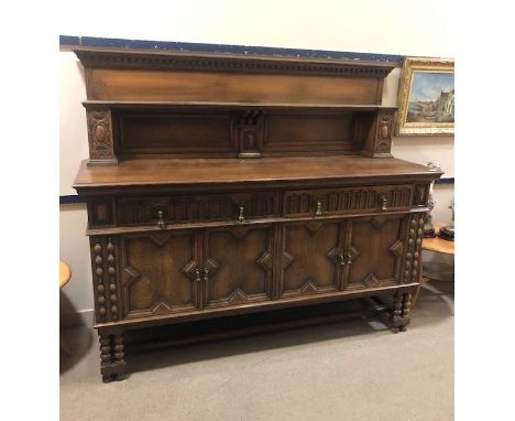EARLY 20TH CENTURY OAK SIDEBOARD, with shelved superstructure over two drawers and four cupboard doors, on bobbin twist suppo