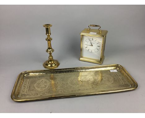 BRASS EMBOSSED RECTANGULAR TRAY, 58.5cm wide, along with other brass ware including a candlestick and a mantel clock (7)