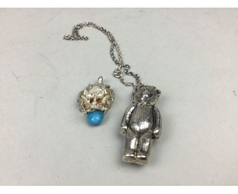 SILVER TEDDY BEAR PENDANT, on chain, along with a white metal dragon's head pendant (2)