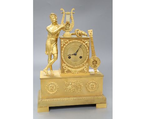 A French Empire design ormolu eight day mantel clock, the case surmounted with a Grecian figure playing a lyre, height 31cmCO