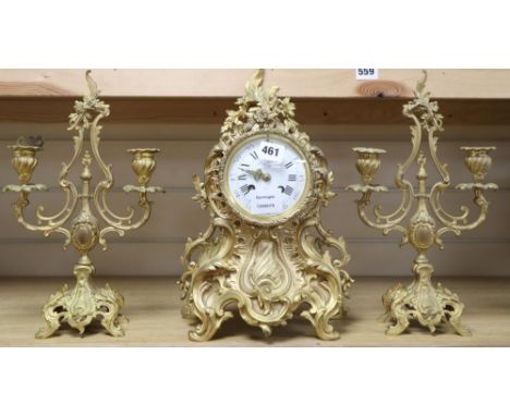 A Louis XV design cast ormolu rococo eight day mantel clock, with matching two branch candelabra, by Aug Le Roy, height 37cm