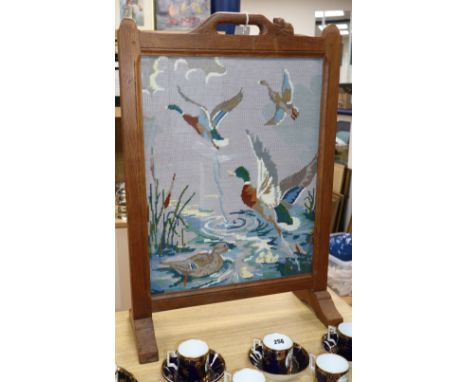 A 'Beaverman' oak firescreen, with embroidered 'duck' panel, height 74cm