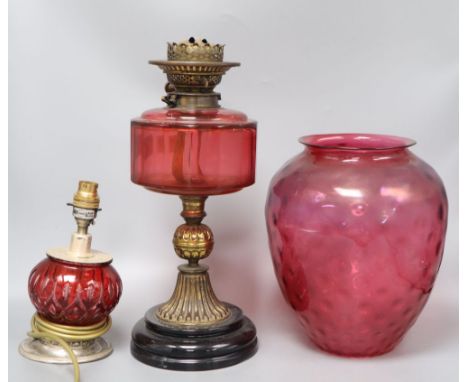 A cranberry oil lamp and shade, 49cm excl. shade, and a small cranberry table lamp