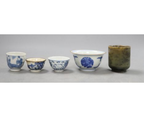 A group of Chinese cups, four ceramics, one jade and some have marksCONDITION: The smallest cup with the gold-painted rim has