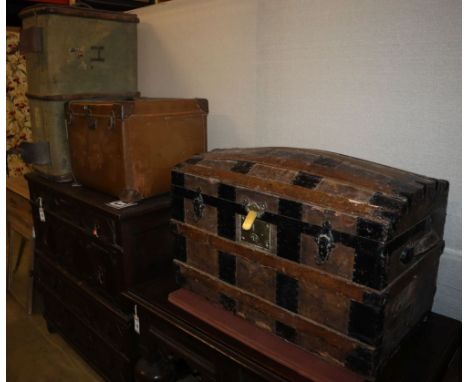 An early 20th century metal bound domed topped steamer trunk, W.76cm, a leather bound trunk and another