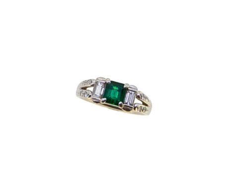 An emerald and diamond ring, claw set square faceted emerald, known stamped weight 0.78ct, flanked by two baguette cut diamon