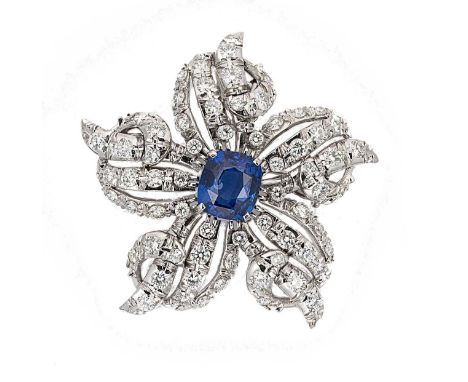 A sapphire and diamond floral pendant/brooch, claw set cushion shaped sapphire, approximately 13.3 x 11.85 x 7.05mm, estimate