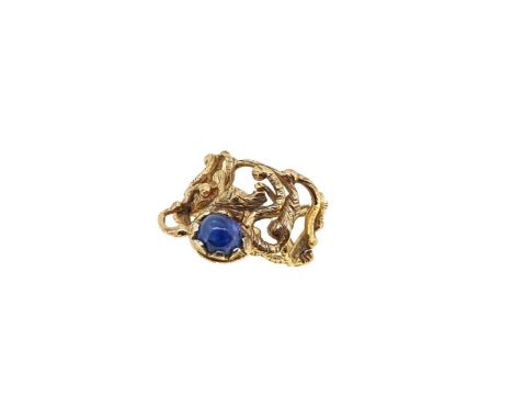 A modern 9ct gold sapphire dress ring, abstract style with a textured finish, set with an oval shaped cabochon sapphire, appr