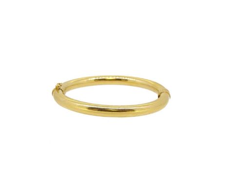 A modern hinged bangle, plain and polished with a push-in clasp and figure of eight safety catch, width 7mm, inside diameter 