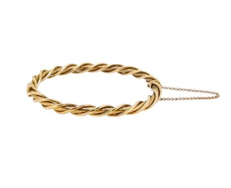 A twist style bangle, narrow bar with applied twist decoration, inside diameter 5.5cm, width 5.5mm, push-in clasp with safety