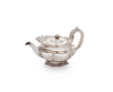 A George IV silver teapot, mark of Benjamin Smith II, London 1829, of circular panelled form with applied cast foliate parape