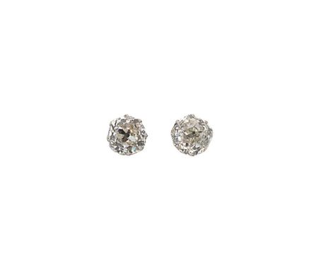 A pair of single stone diamond ear studs, claw set old mine cut diamonds, average dimensions 7.15 x 7.05 x 4.9mm, estimated a