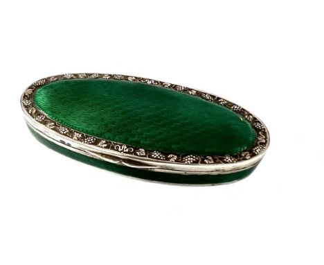 An early 20th century silver and enamel snuff box, possibly of French origin, of oval form, the side with a band of dark gree