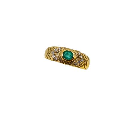 An emerald and diamond dress ring, rubover set oval faceted emerald, estimated approximate weight 0.20ct, further set with te