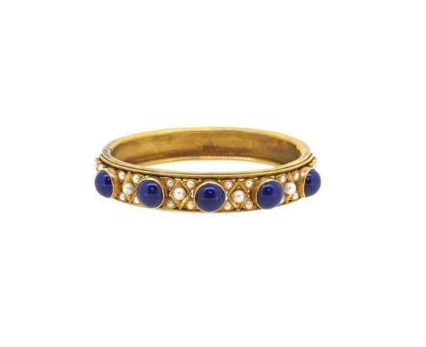A lapis lazuli and pearl set hinged bangle, the front section set with five round cabochon lapis lazuli, each spaced by a clu