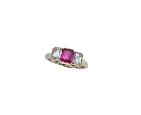 A ruby and diamond three stone ring, partially rubover set octagonal ruby, estimated approximate weight 0.90ct, flanked by tw