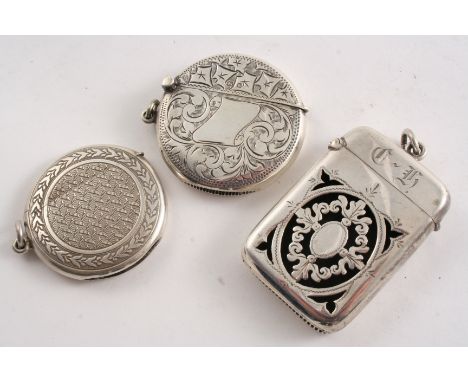 A LATE VICTORIAN SILVER VESTA CASE with a pierced front, initialled, an Edwardian silver circular vesta case with engraving a