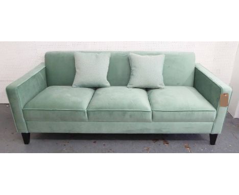 SOFA, three seater, in green velvet on square supports, with a pair of scatter cushions, 192cm L.