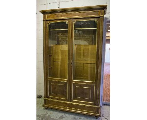 BIBLIOTHEQUE, 19th century Directoire style mahogany and brass mounted with glazed doors and a drawer on turned supports, 232