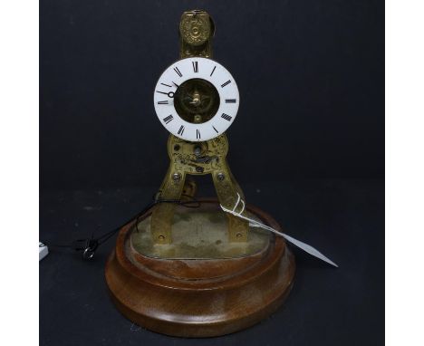 A brass skeleton clock, enamel chapter ring with Roman numerals, drum movement, on circular stand without glass dome, H.18cm 