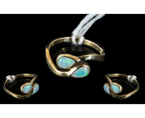 A 9ct Gold Opal Ring Set with Two Tear Shape Opals on a Twist fully hallmarked, ring size L. 