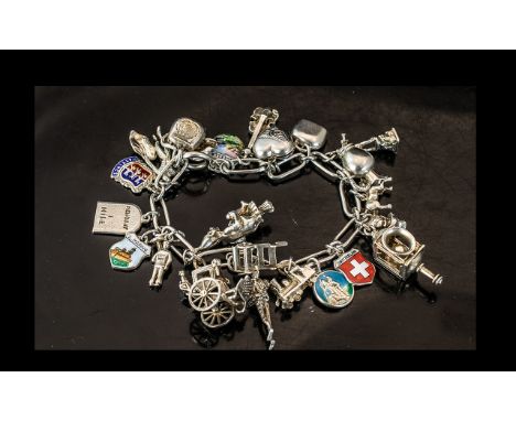 A Good Quality Vintage Sterling Silver Charm Bracelet, Loaded with 25 Silver Charms. All Marked for Silver. Weight 53.5 grams