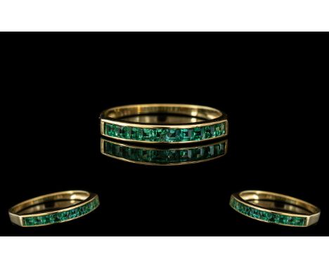 A 14ct Gold Emerald Half Eternity Ring stamped 585. Ring size P. 