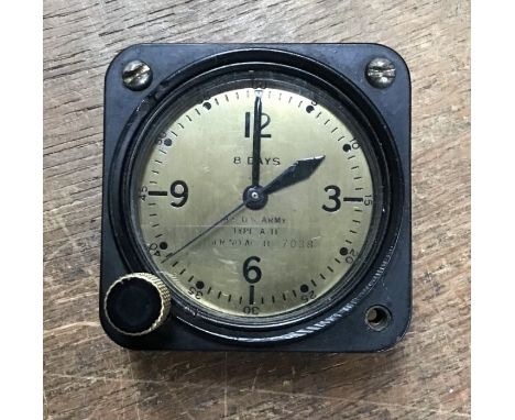 An American WWII aircraft clock, possibly from a bomber, serial number 7038, inscribed on a gold coloured dial, on rear maker