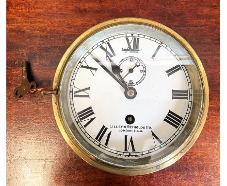 A ships brass bulkhead clock, the white painted dial  with seconds dial signed 'Lilley &amp; Reynolds Ltd London EC3', diamet