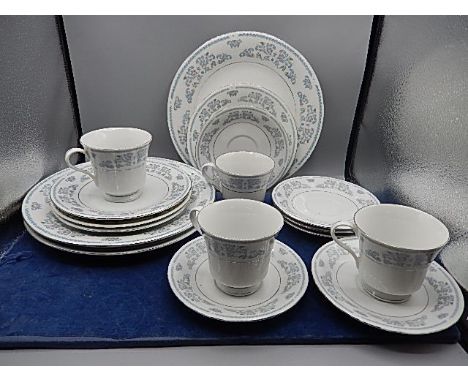 Liling part dinner service, 3 plates, 4 side plates, 4 cups and saucers, pale blue oriental design with silver coloured trim,