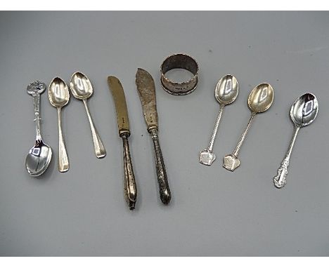 A selection of silver spoons, silver napkin ring and 2 silver handled knives