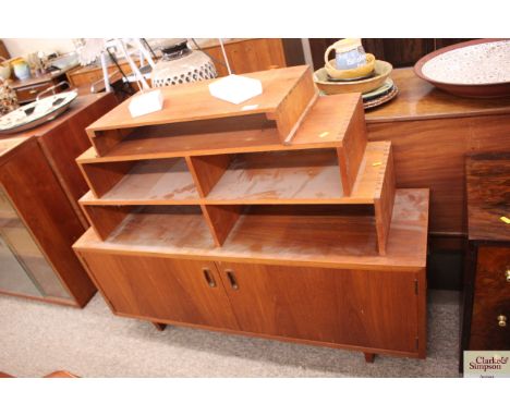 A teak G-plan style low cupboard; and a graduated stacking shelf, 22cm wide x 95cm high overall