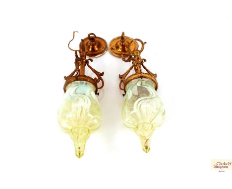 A pair of early 20th Century brass pendant light fittings with Vaseline glass shades