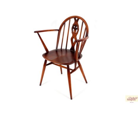 A set of six Ercol stick back dining chairs, four standards, two elbows