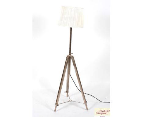A modern metal ware tripod standard lamp and shade