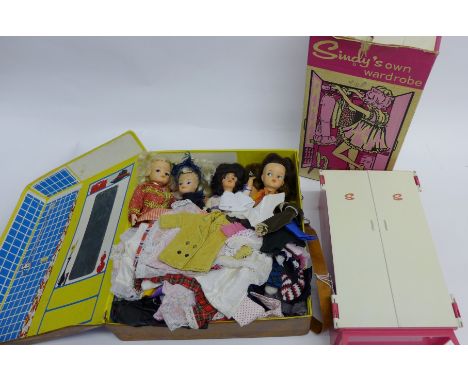 Sindy faux leather travel case containing a collection of nine vintage Sindy dolls and others together with Sindy's own wardr