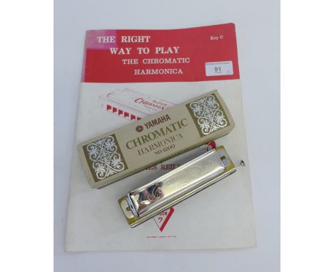 Yamaha Chromatic Harmonica No. 1200, together with a music book (2) 