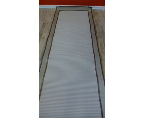 A modern canvas edged beige woollen runner, 50 x 107cm 