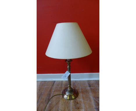 A brass stemmed table lamp base with shade 