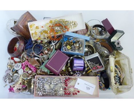 A large quantity of vintage and later costume jewellery to include beads, brooches, and rings etc 