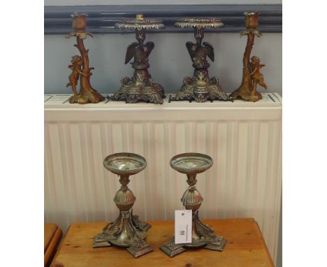 A pair of gilt metal cherub candlesticks, a pair of Epns candlesticks and an Epns pair of eagle stemmed candlesticks, convert