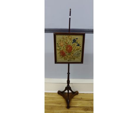 A 19th century mahogany fire pole with tapestry panel, raised on bun feet,150 x 44cm 