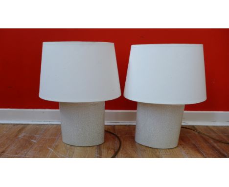 A pair of cream glazed craquelure table lamp bases complete with shades (2) 