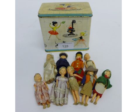 A vintage tin containing a group of nine small dolls all in various outfits.  (10)