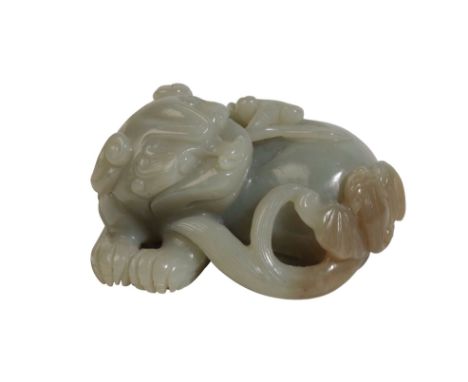 CELADON JADE CARVED FIGURE OF A LION DOG grasping lingzhu fungus in its mouth, Width: 6cm