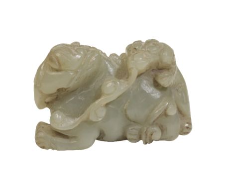 CARVED CELADON JADE GROUP, QING DYNASTY modelled as a lion dog crawling atop a recumbant elephant, Height: 4cm  
